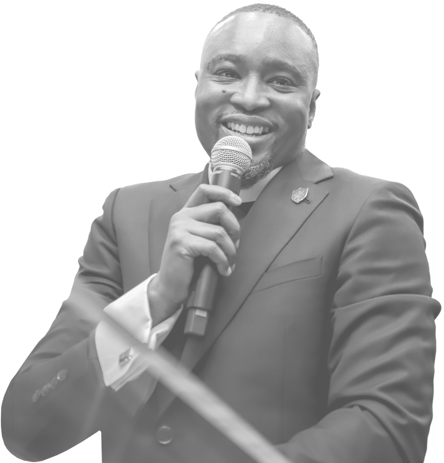 Rev. Dr. Edward Jones IV smiling and holding a microphone